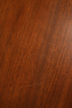 Maker's label close-up inside walnut wood desk showing vintage identification mark and visible joinery craftsmanship