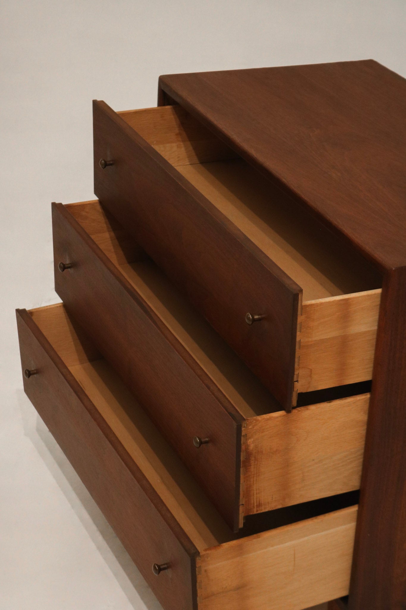 Lower drawers close-up showing aligned handles and original MCM craftsmanship