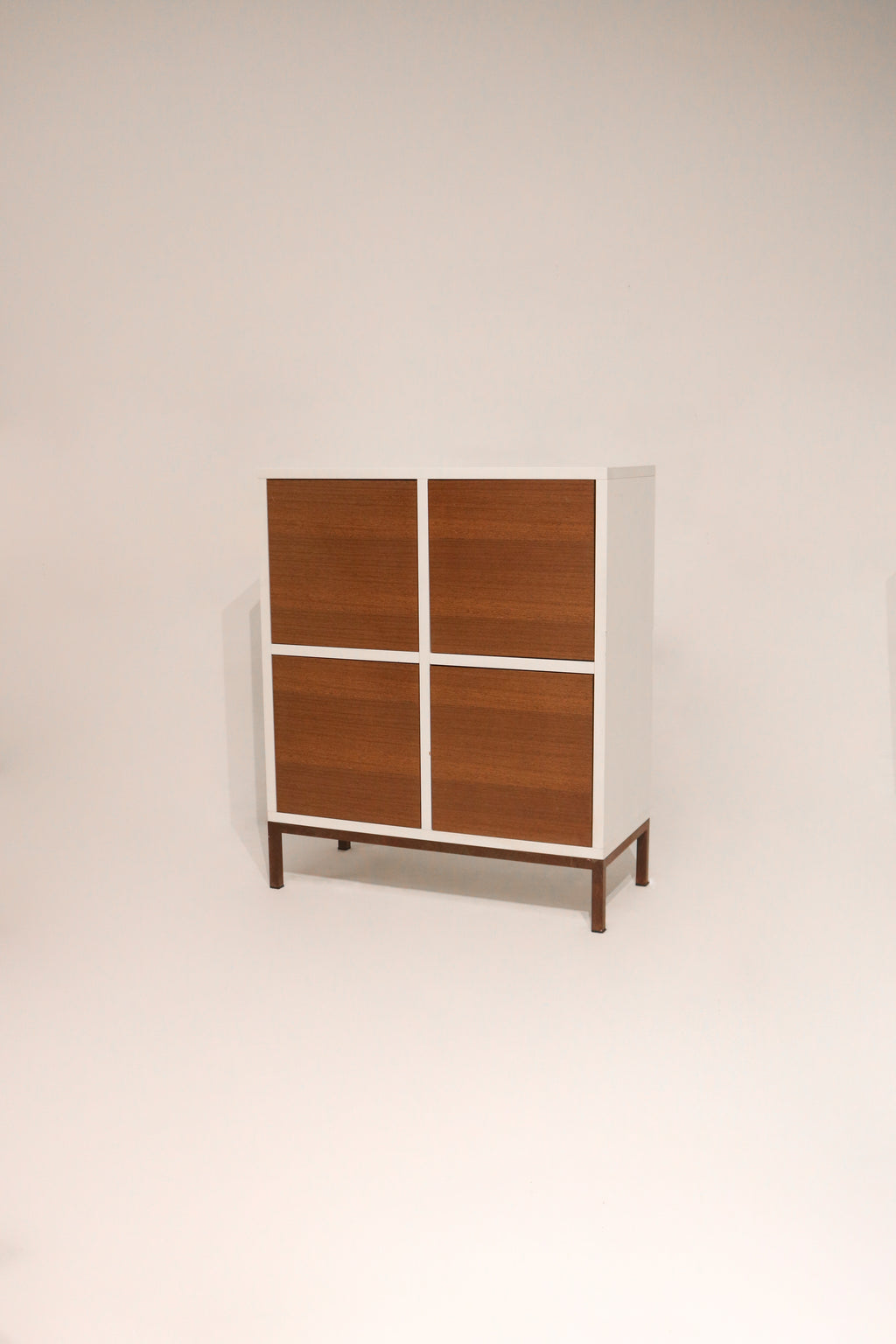 Front view of modern custom wood storage cabinet with doors and iron legs in NYC