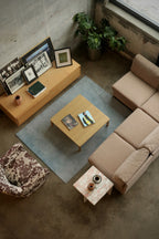 Close view of cushion corner showing fabric wear patterns, precise stitching and preserved padding on vintage MCM fabric sofa