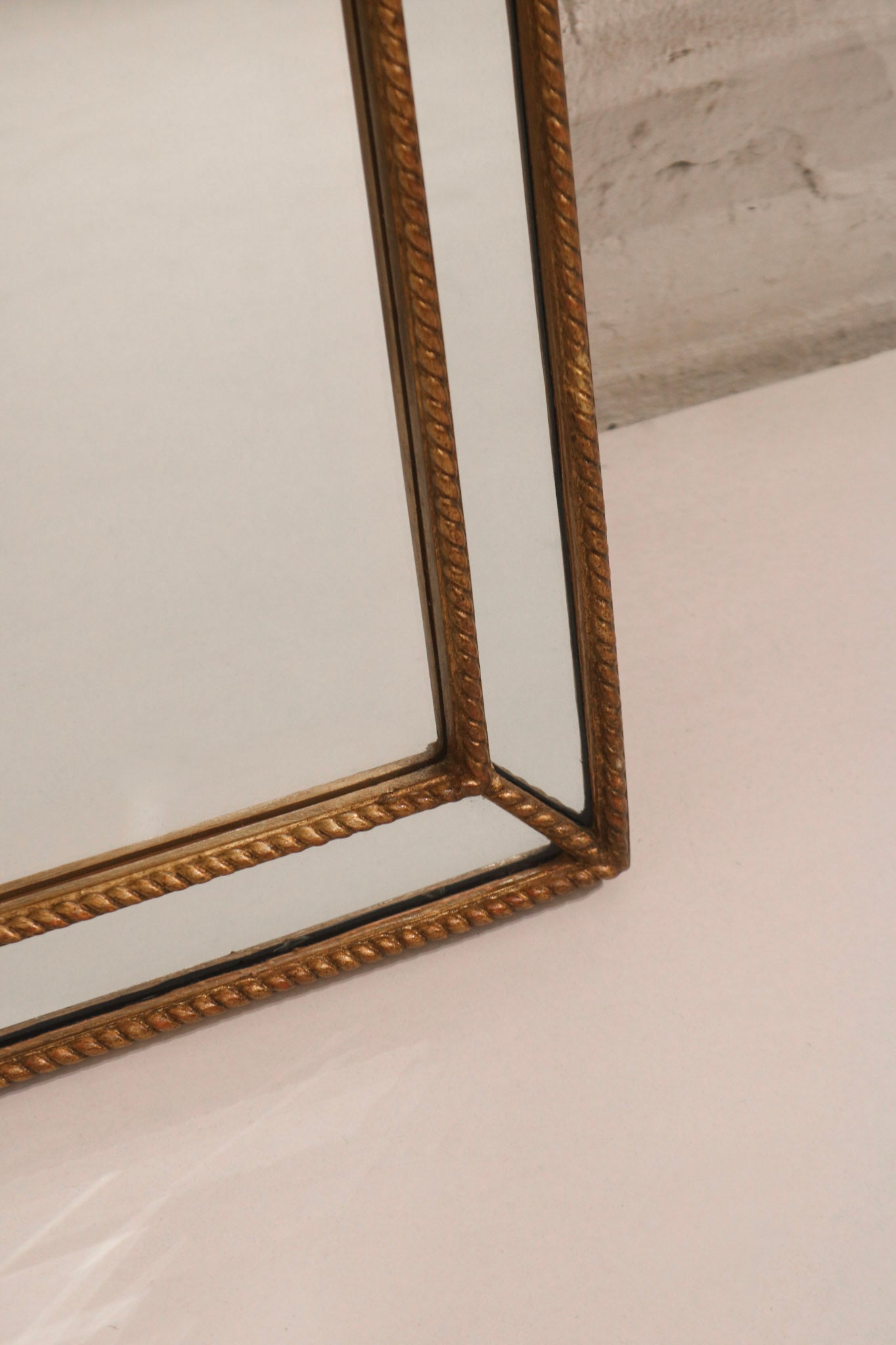 Texture detail of solid wood golden frame, showing vintage patina and light wear