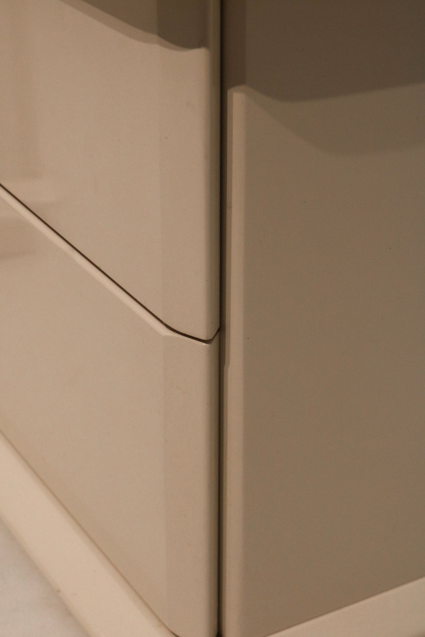 Detailed view of upper drawer construction in white lacquered MCM nightstand