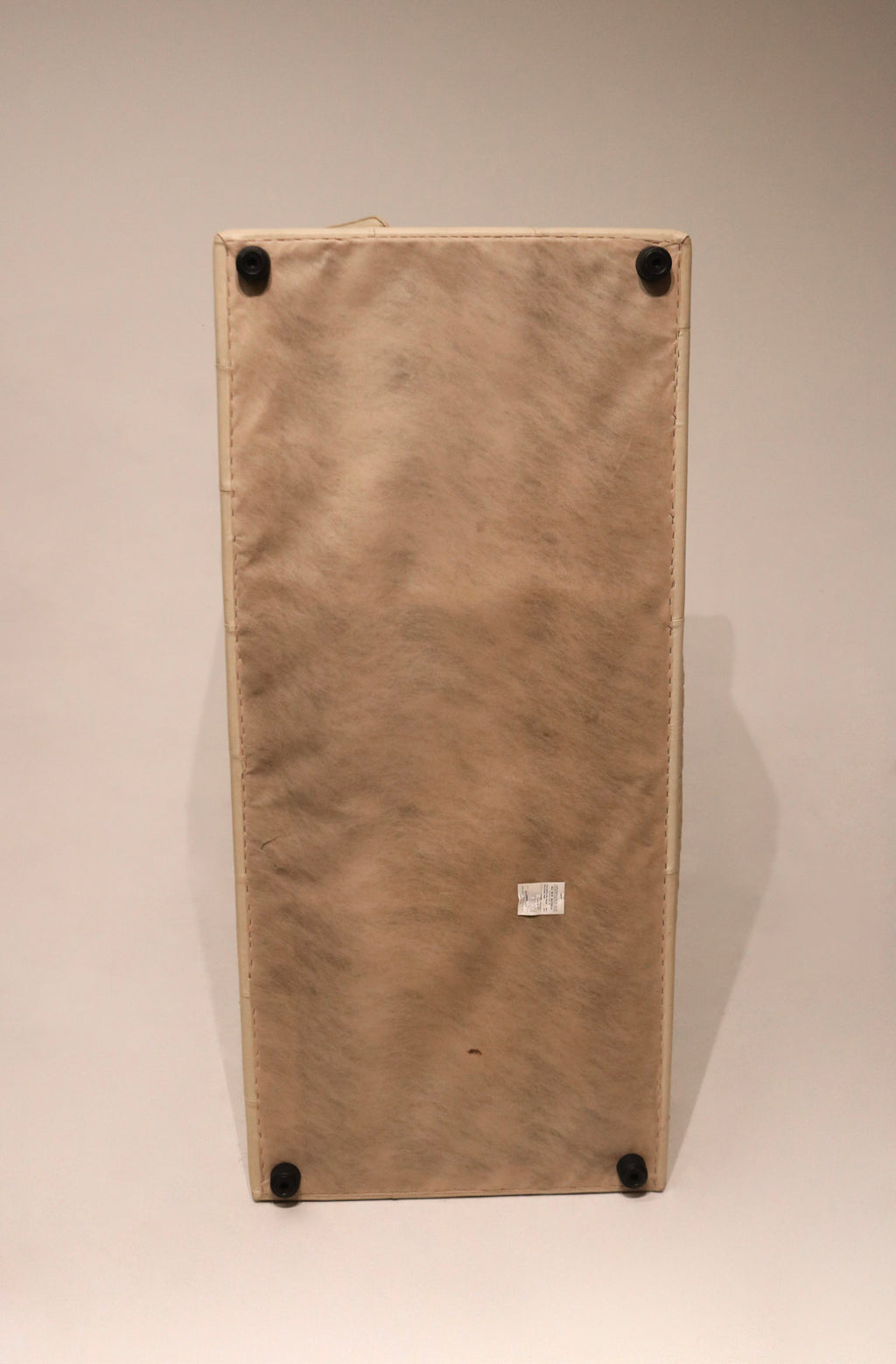 Detail of stitching and seam lines on beige Italian leather sofa, precision craftsmanship