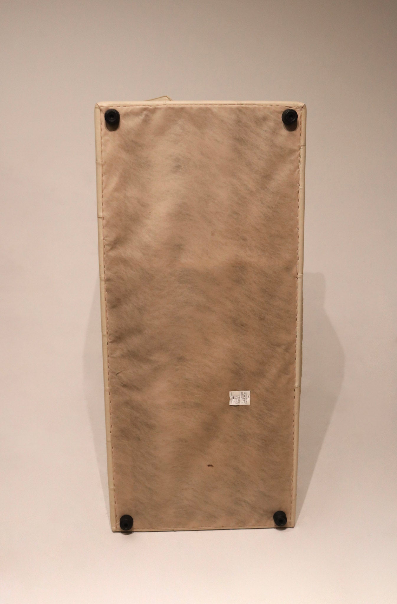 Detail of stitching and seam lines on beige Italian leather sofa, precision craftsmanship