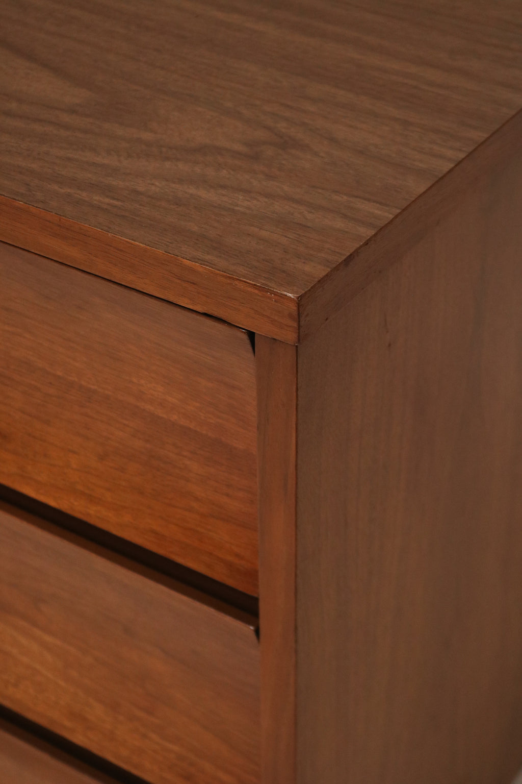 Vintage metal hardware on the walnut wood dresser highlighting mid-century modern design