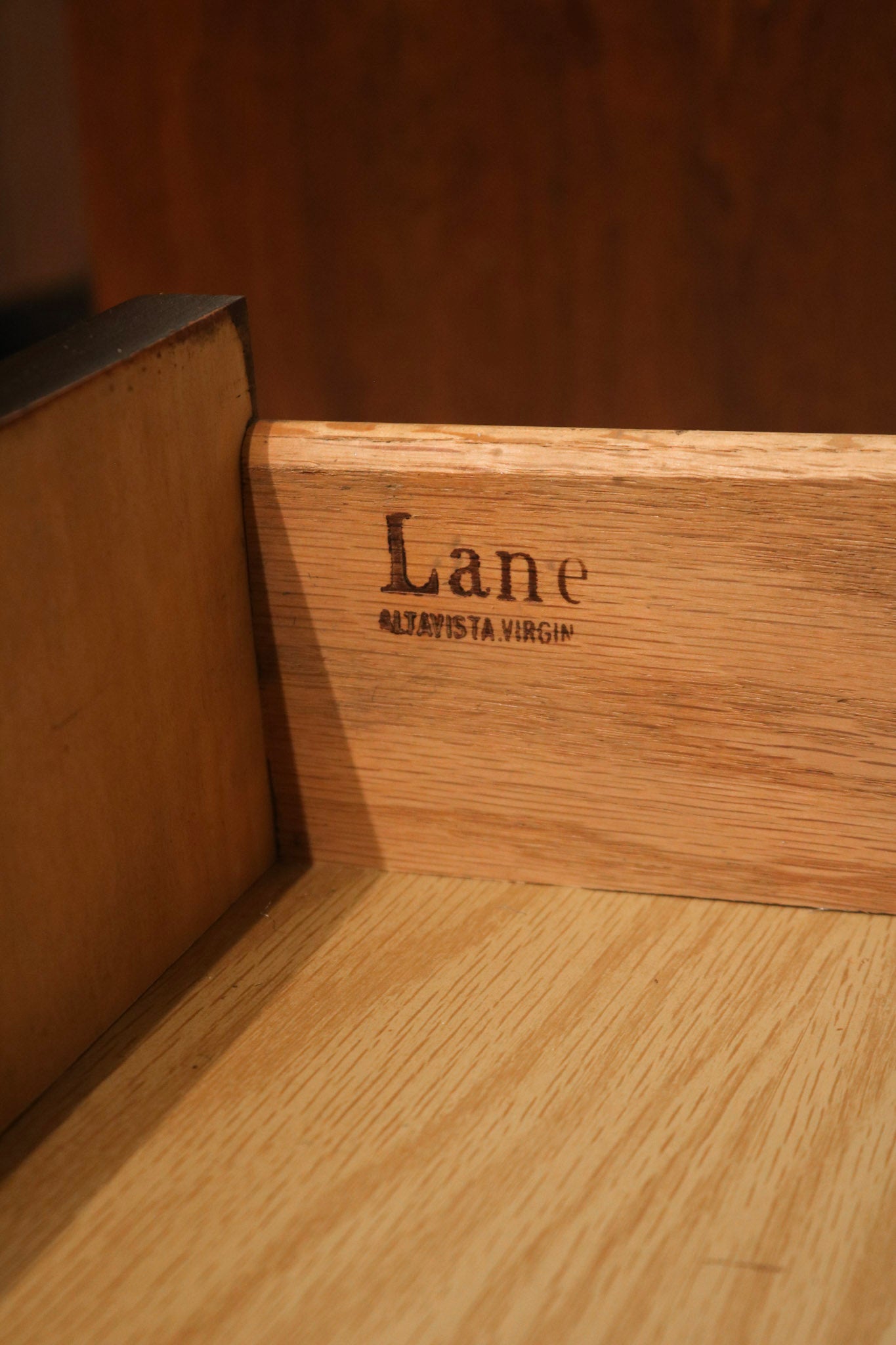Hardware close-up: original metal pulls on walnut drawers, patina and mounting hardware visible against wood grain