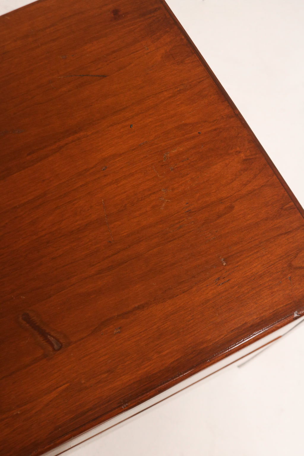 Bottom view focusing on missing wood part from the right leg, subtle imperfection