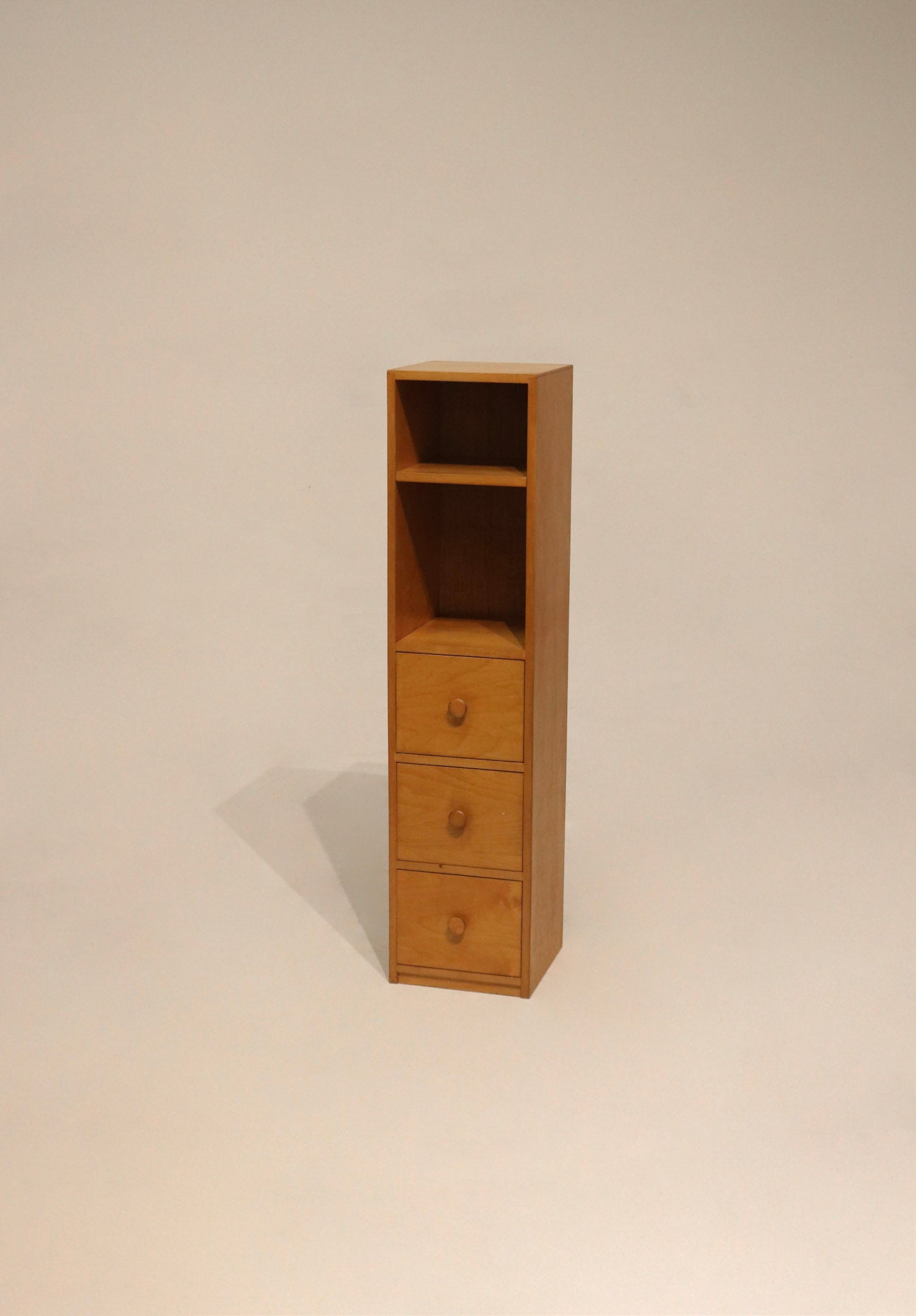 Front view of tall thin oak wood bookcase cabinet with particle board accents