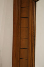Detail of oak wood frame showing maker's marks, screw heads, patina and finish imperfections that confirm vintage origin.