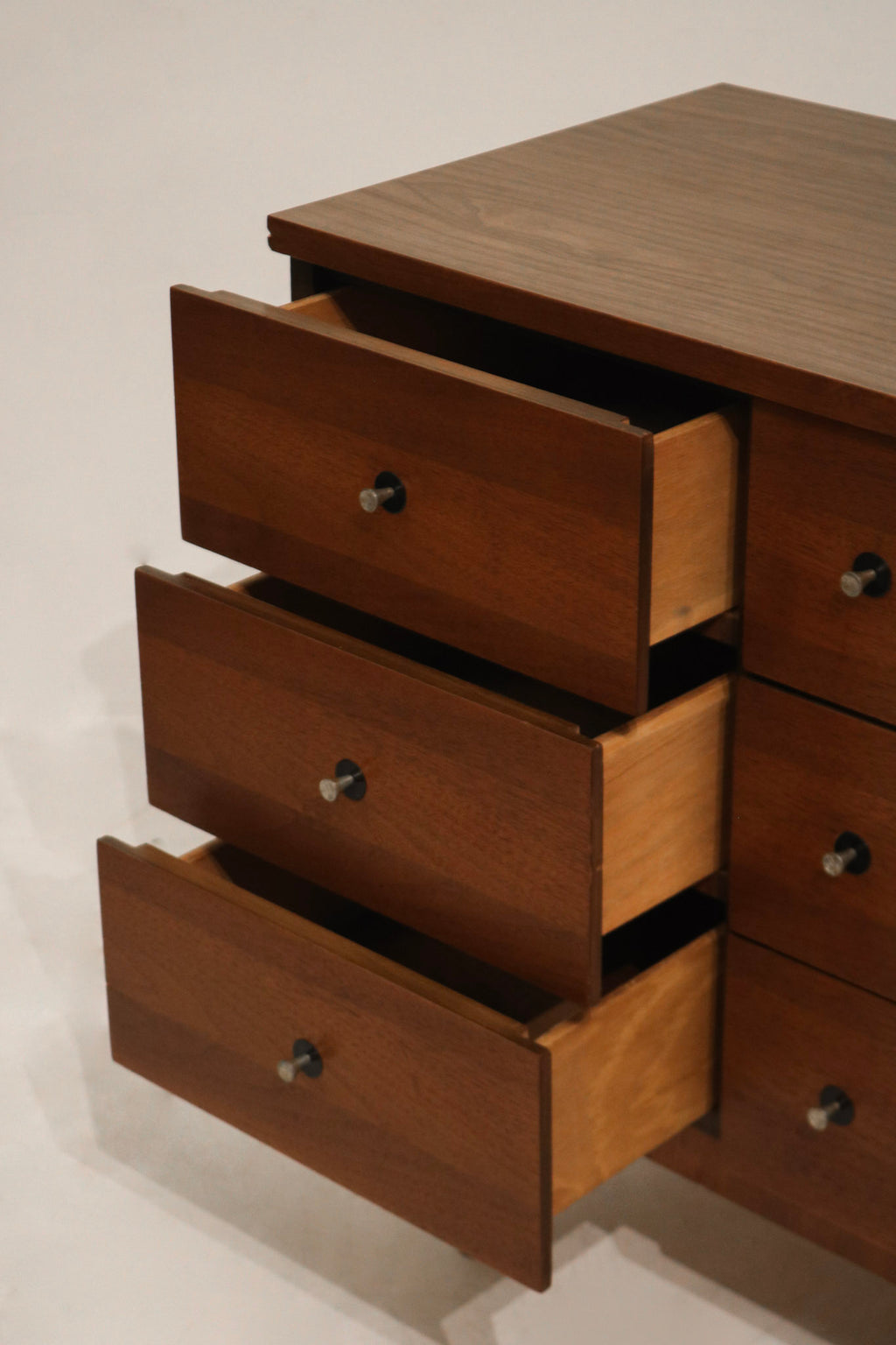 Bottom leg detail highlighting the gently tapered mid-century legs in walnut finish