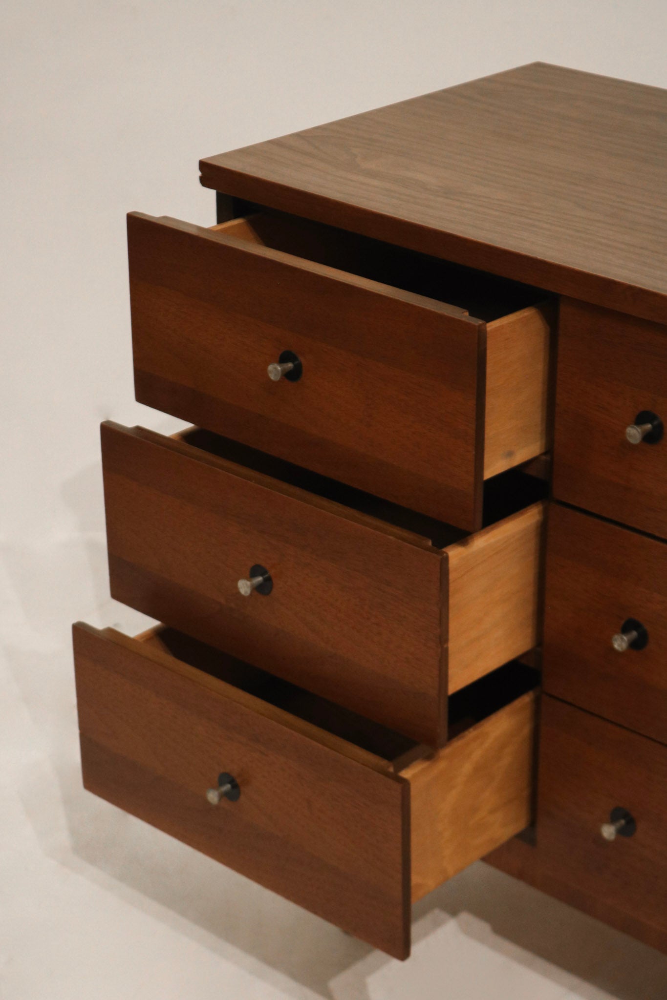 Bottom leg detail highlighting the gently tapered mid-century legs in walnut finish