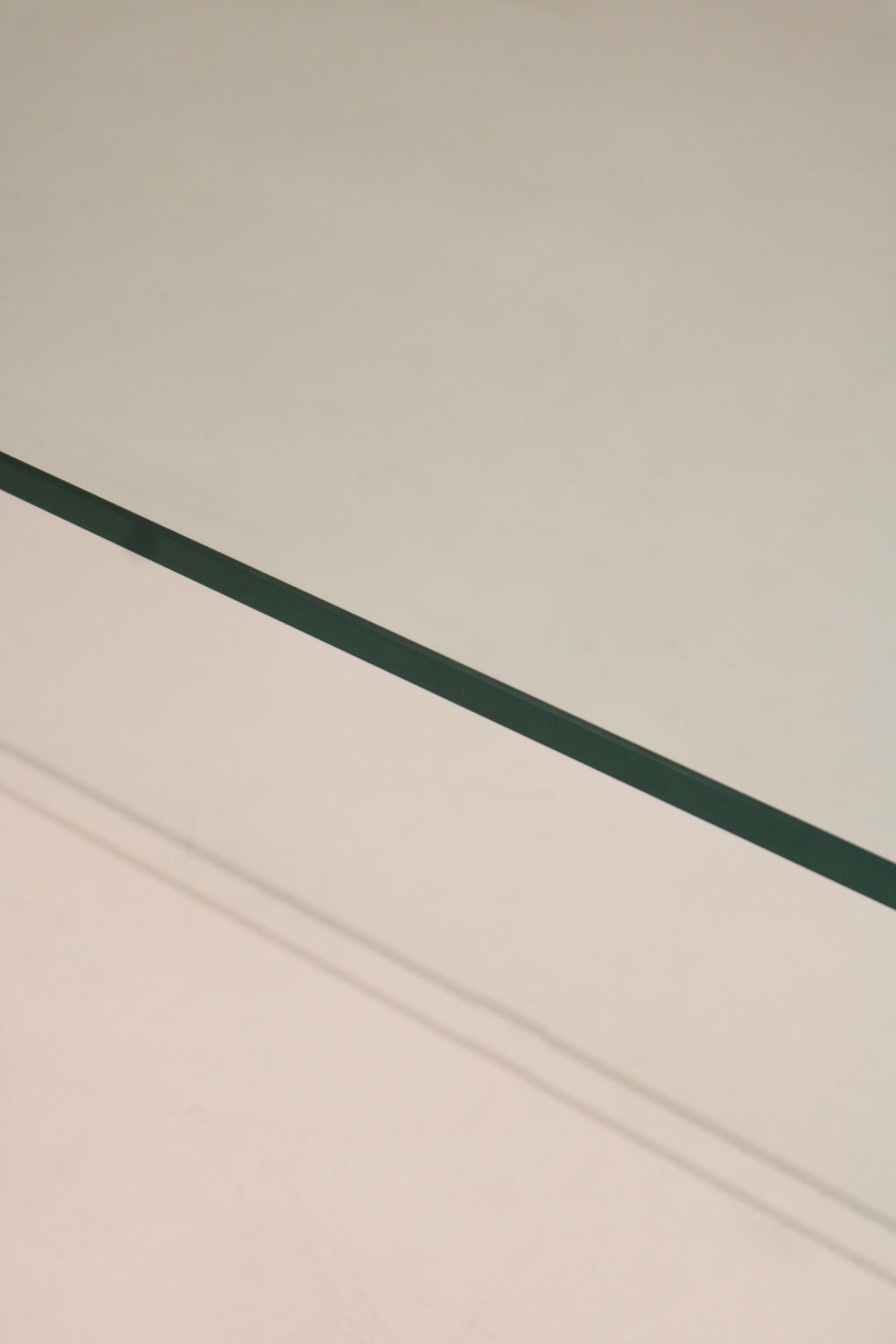 Detail of the curved edge and seamless glass bend on this Contemporary Modern waterfall coffee table