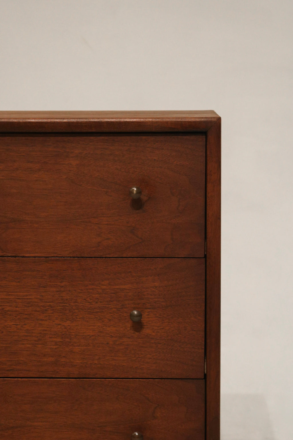 Corner view showing the smooth edges and warm walnut tone of the Mcm bedside table