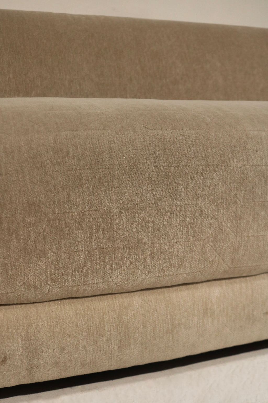 Photo of back frame and fabric wrap on Contemporary West Elm sofa, champagne velvet upholstery and visible support structure in clean condition