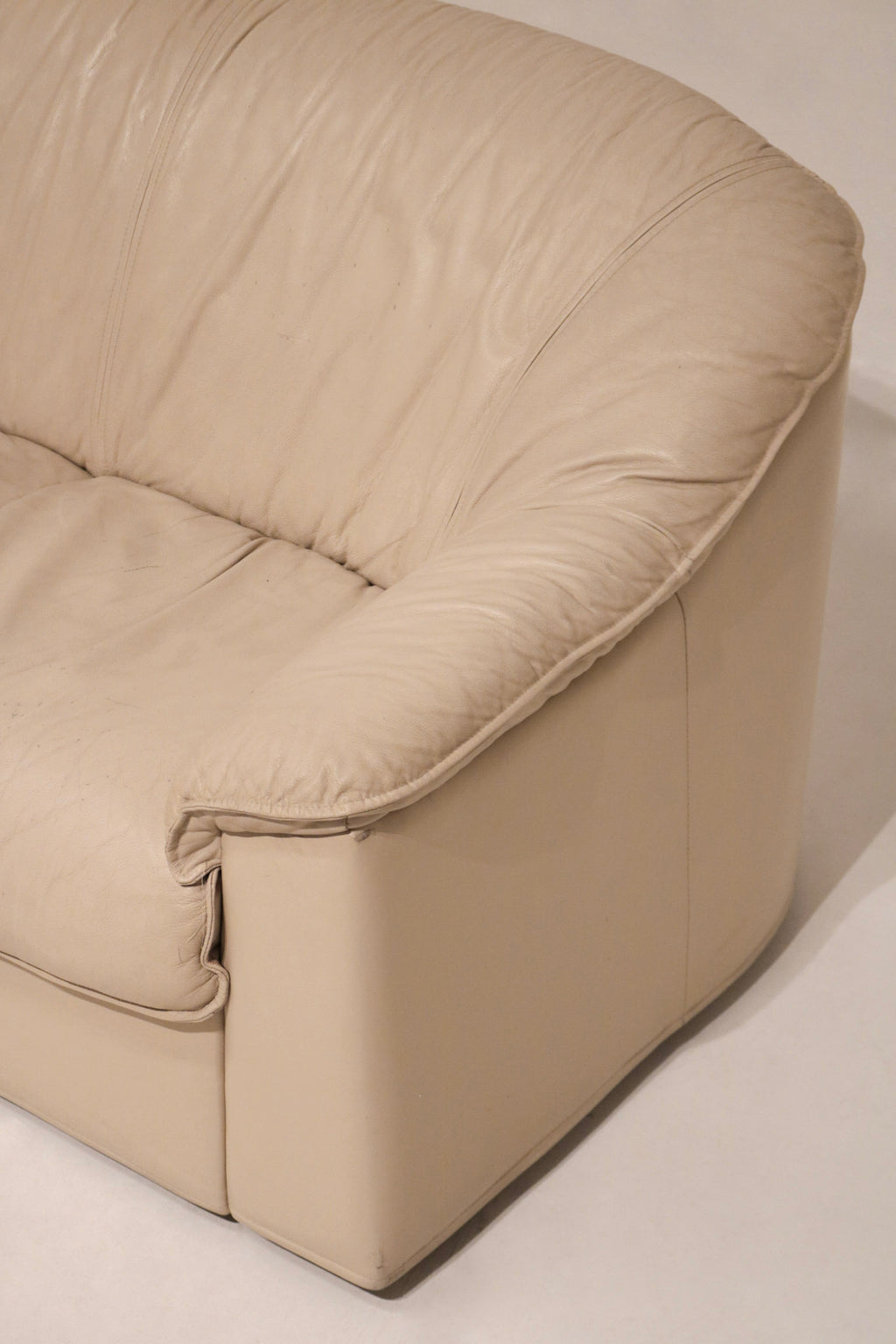 Full front-facing view of Italian leather Salotti Natuzzi sofa with seat cushions visible