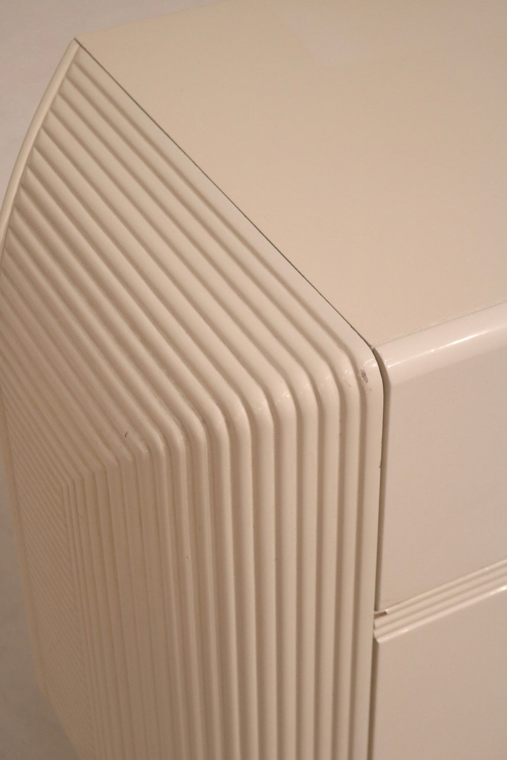 Side angle of the wood dresser emphasizing layered construction and postmodern style