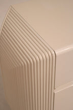 Side angle of the wood dresser emphasizing layered construction and postmodern style