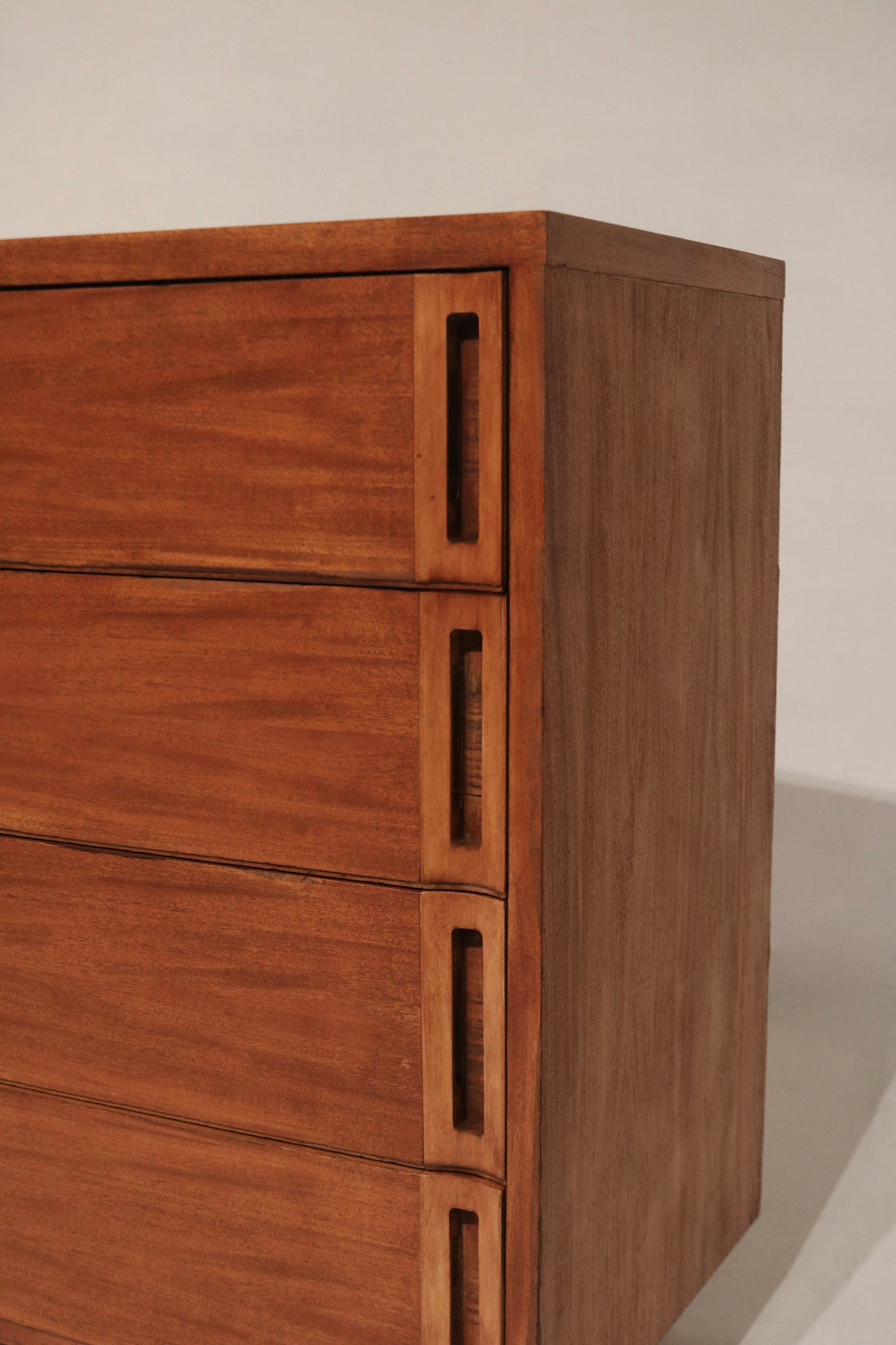 Close-up of drawer glide area and underside edge on solid wood dresser, well-maintained construction and smooth operation visible