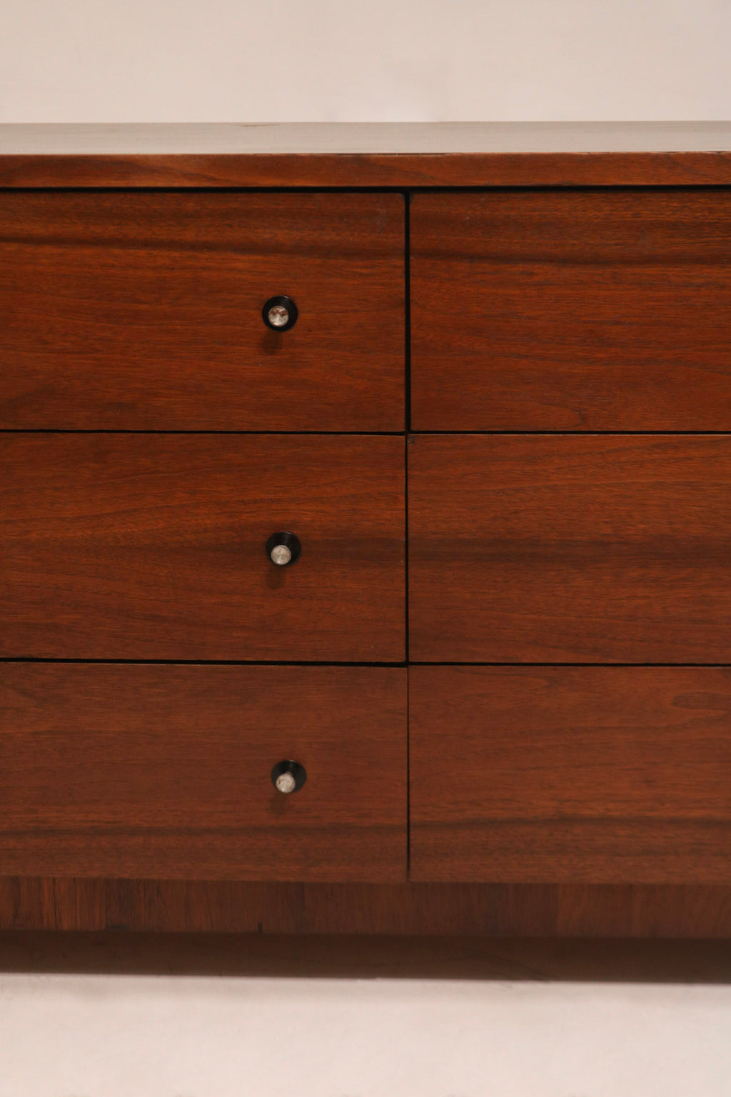 Angled view capturing dresser’s symmetrical drawer alignment and lowboy silhouette