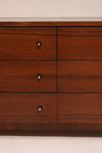 Angled view capturing dresser’s symmetrical drawer alignment and lowboy silhouette