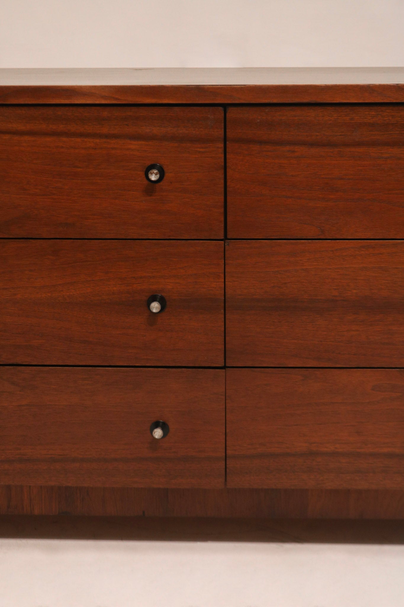 Angled view capturing dresser’s symmetrical drawer alignment and lowboy silhouette