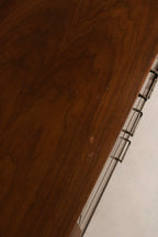 Lower view of tapered legs and base showing sturdy solid wood construction and MCM silhouette in walnut