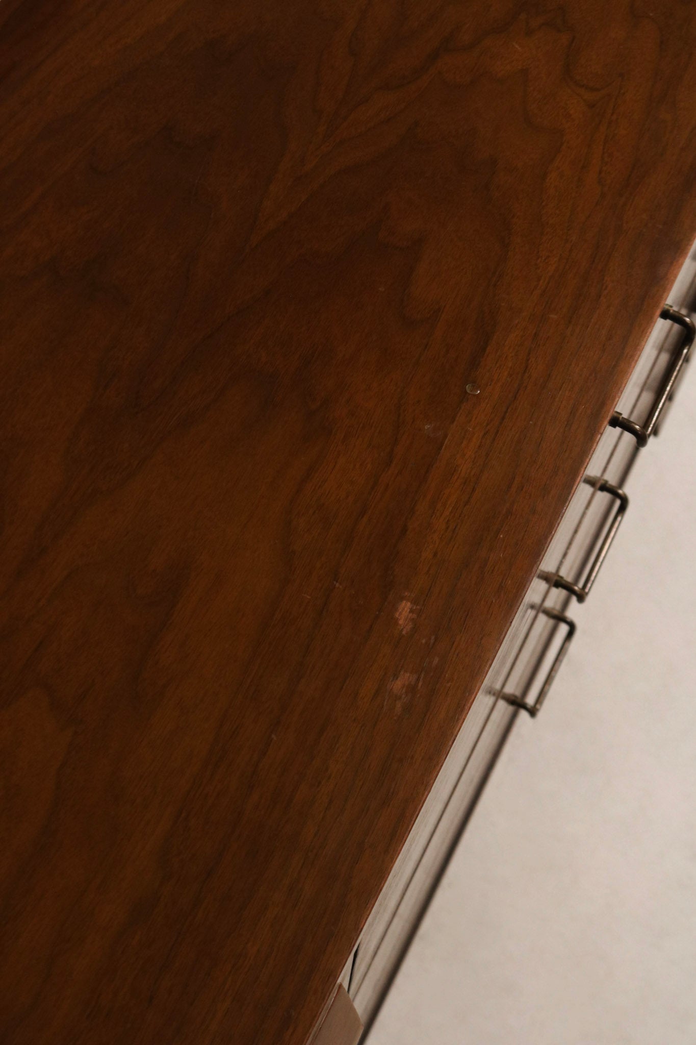 Lower view of tapered legs and base showing sturdy solid wood construction and MCM silhouette in walnut