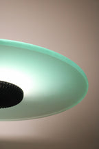 Bottom view of lamp base showing stability and metallic accent against smooth floor surface