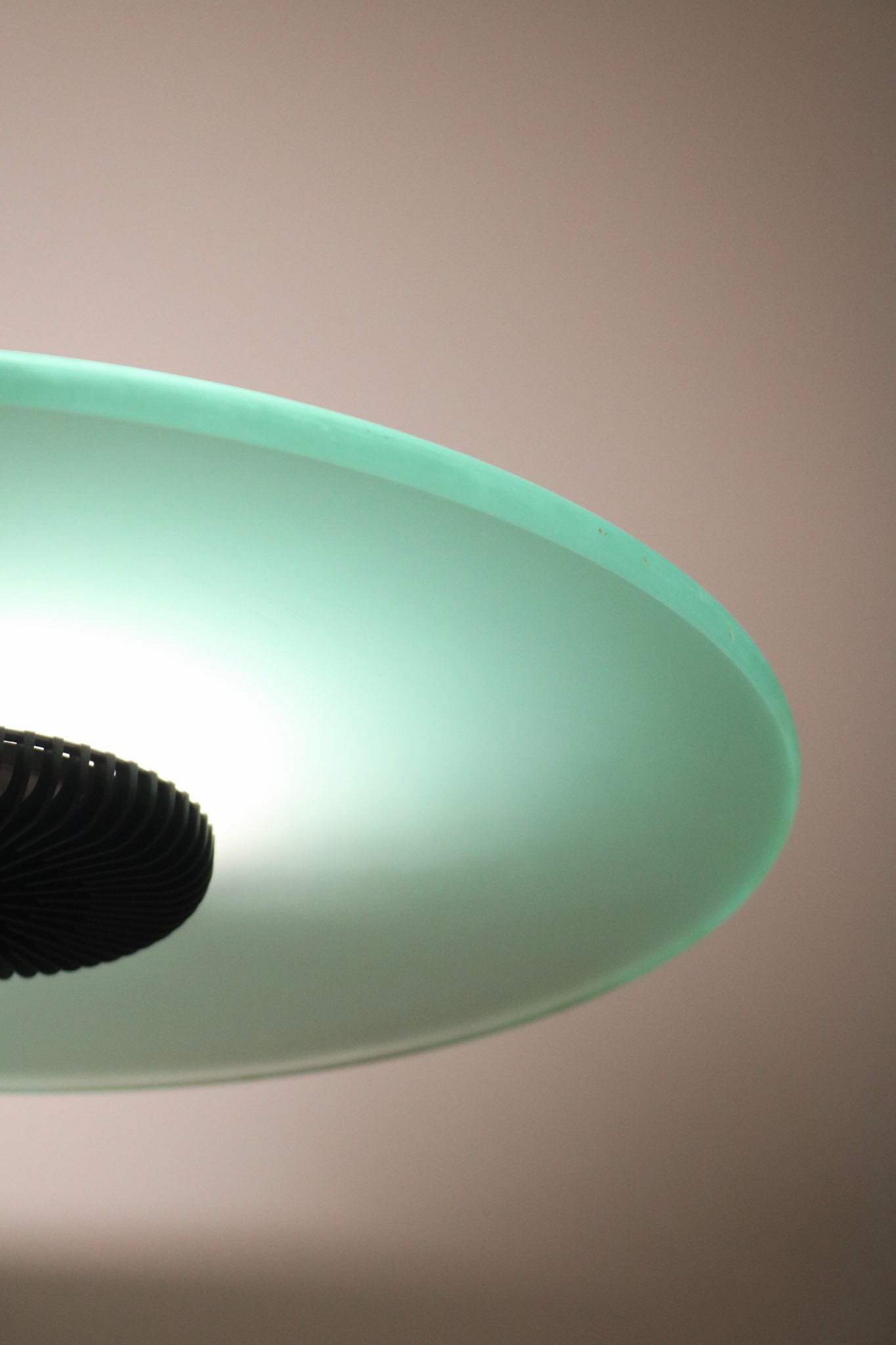 Bottom view of lamp base showing stability and metallic accent against smooth floor surface