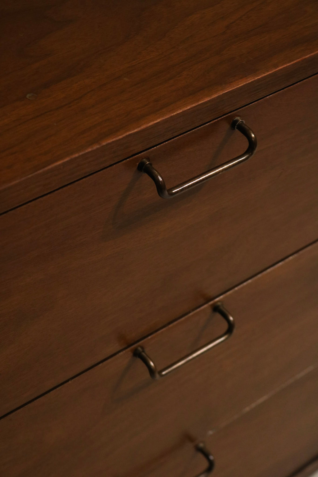 Top edge detail showing tiny marks and surface wear that are not very noticeable on walnut finish