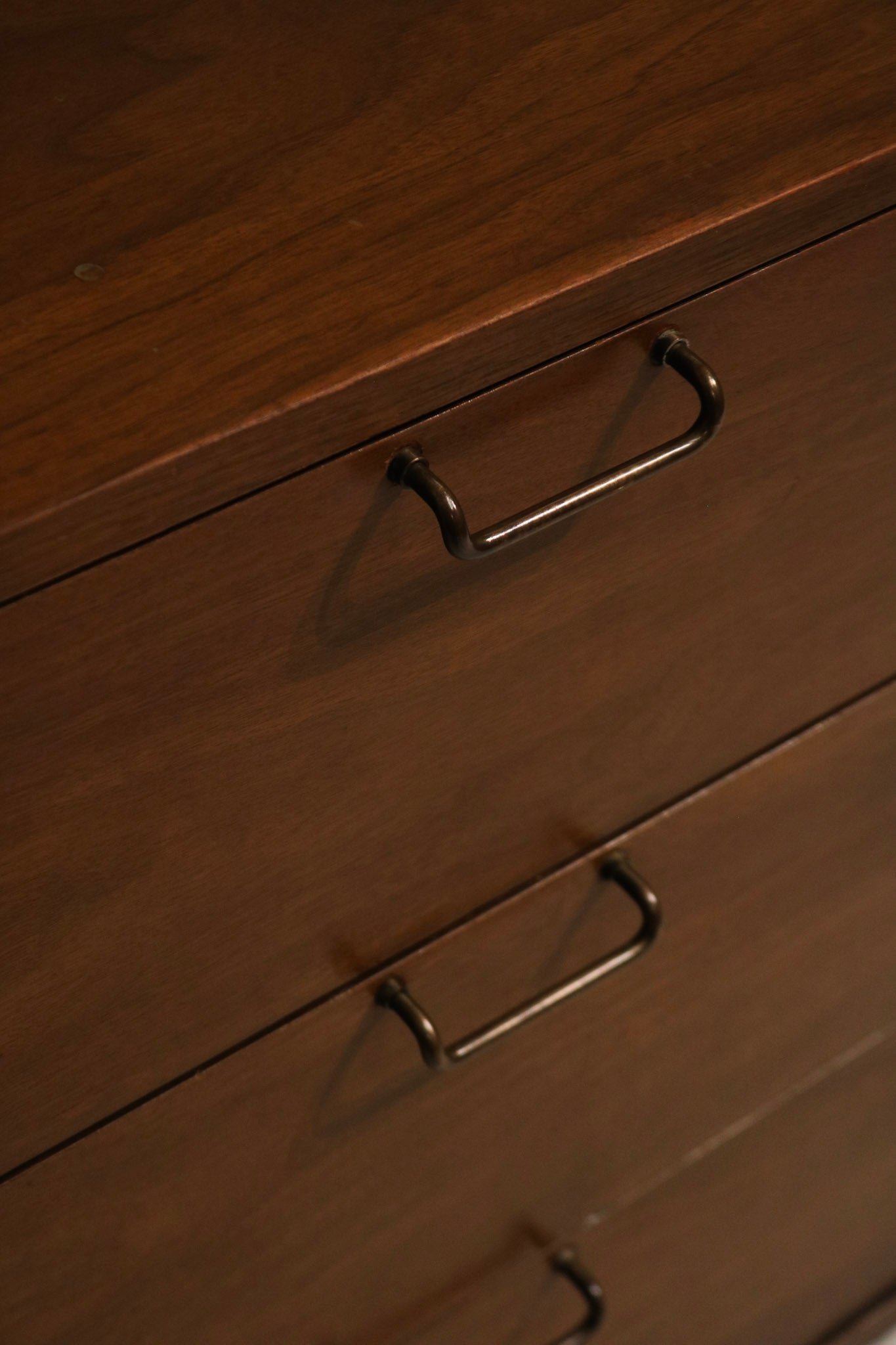 Top edge detail showing tiny marks and surface wear that are not very noticeable on walnut finish