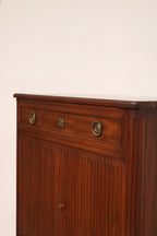 Close-up of the rich mahogany wood grain texture on the dresser's front panel, highlighting smooth finish