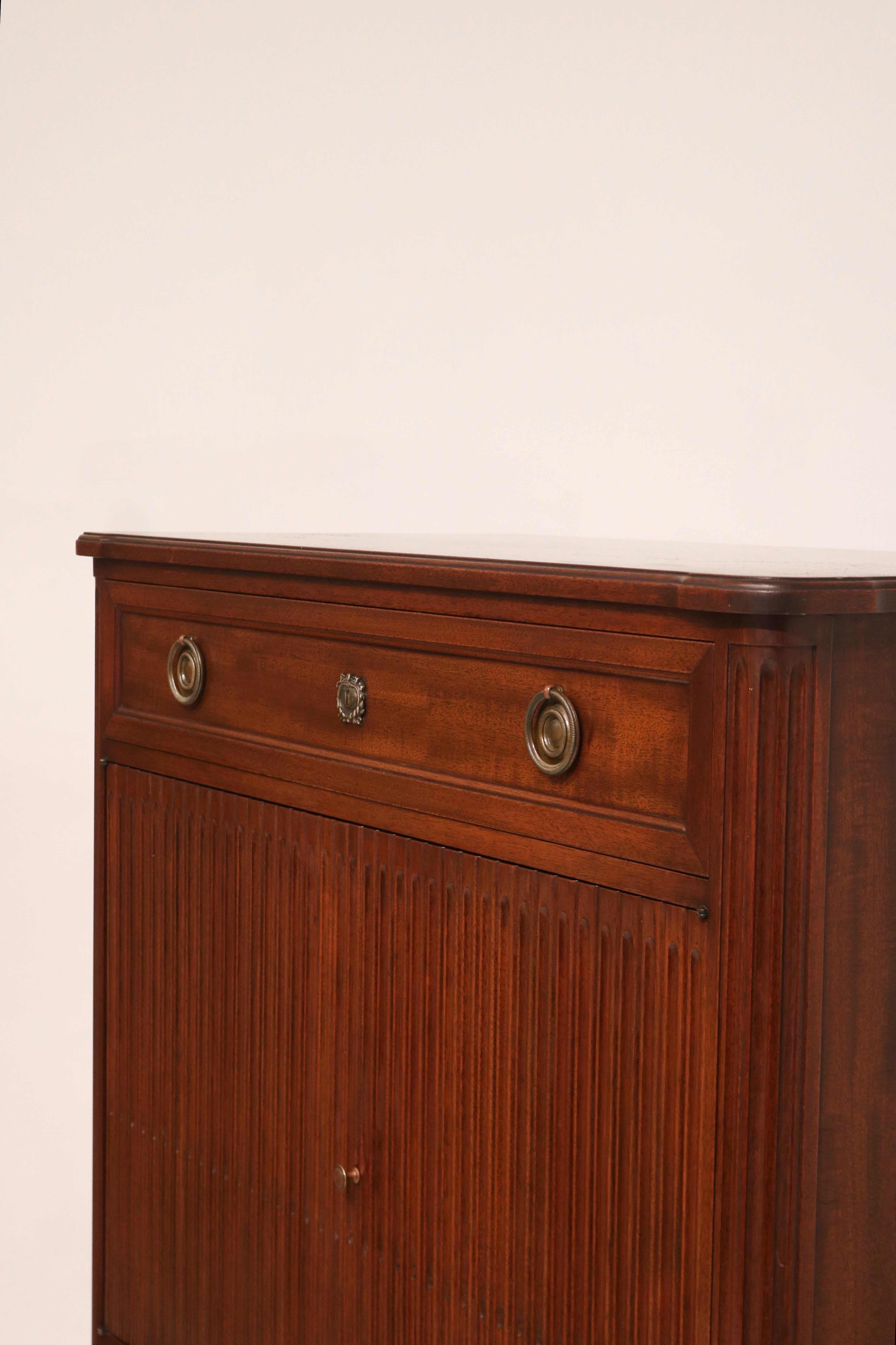 Close-up of the rich mahogany wood grain texture on the dresser's front panel, highlighting smooth finish