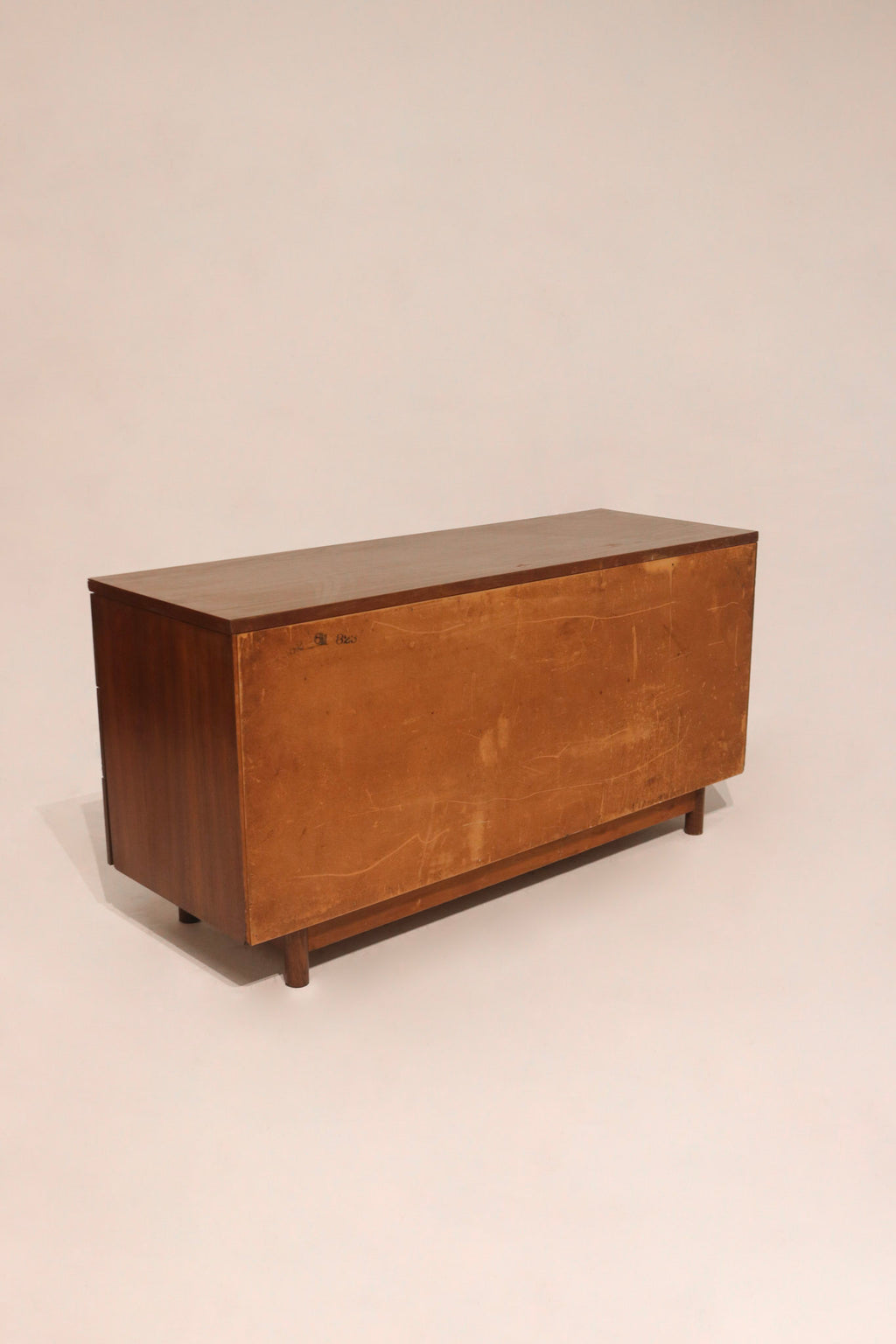 Close-up of walnut veneer top surface on Mcm dresser showing rich grain texture and color tone