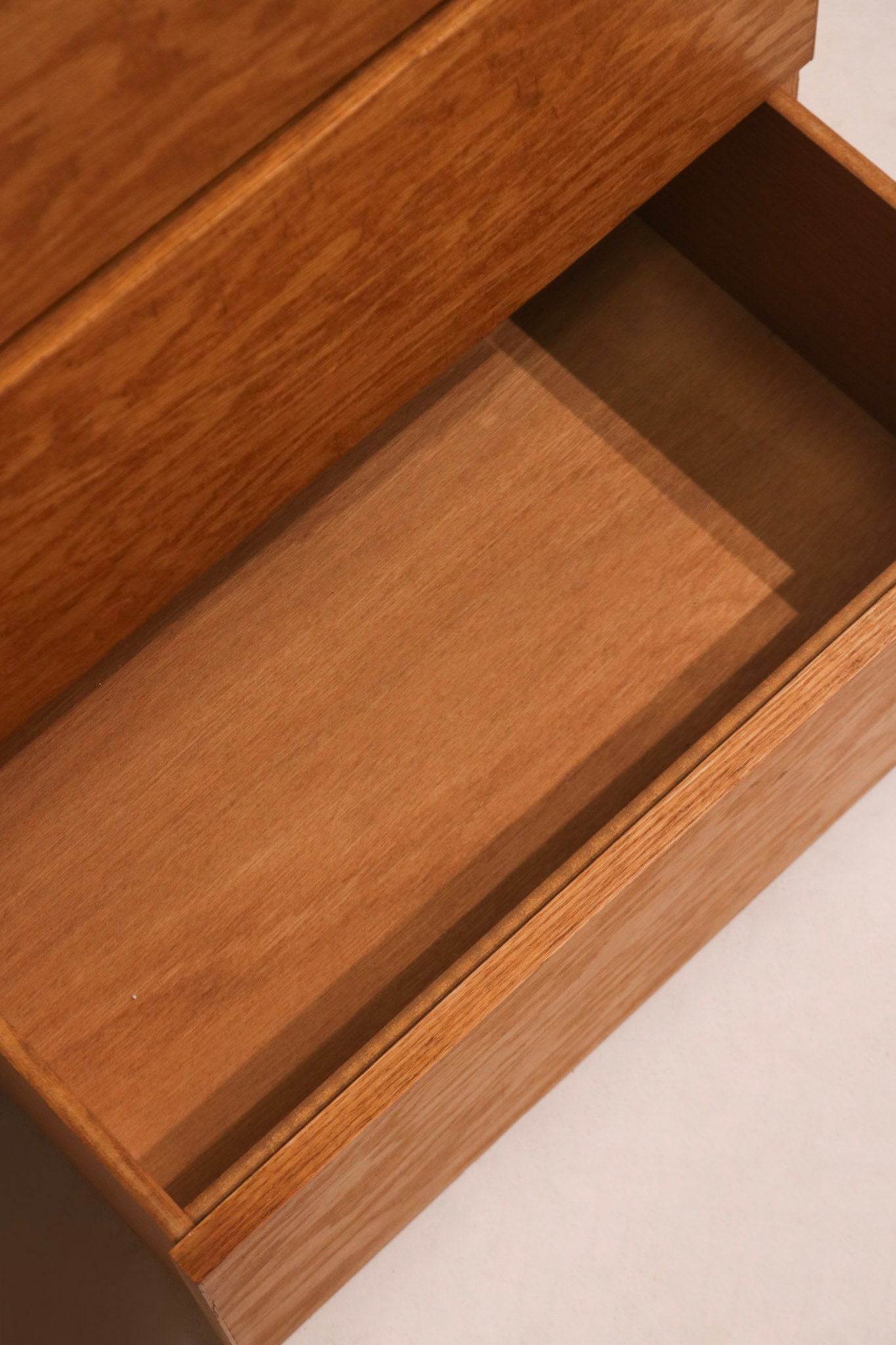 Bottom corners showing subtle chips and oak wood grain details