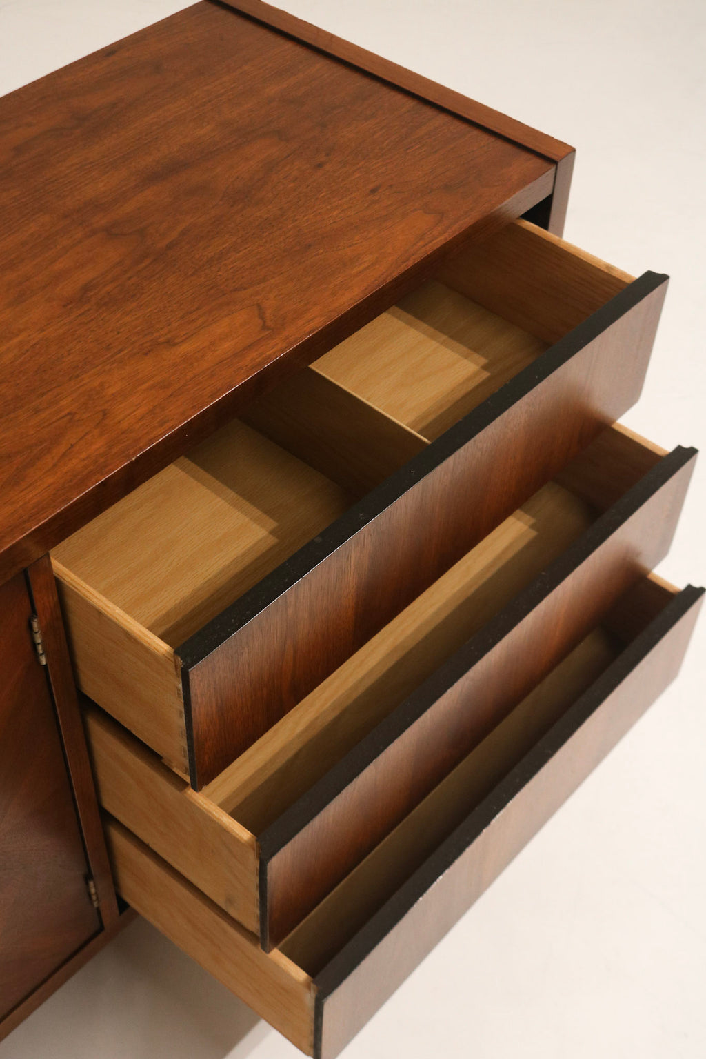 Drawer slide detail showing well functioning hardware and smooth operation, original mid-century assembly in wood drawers