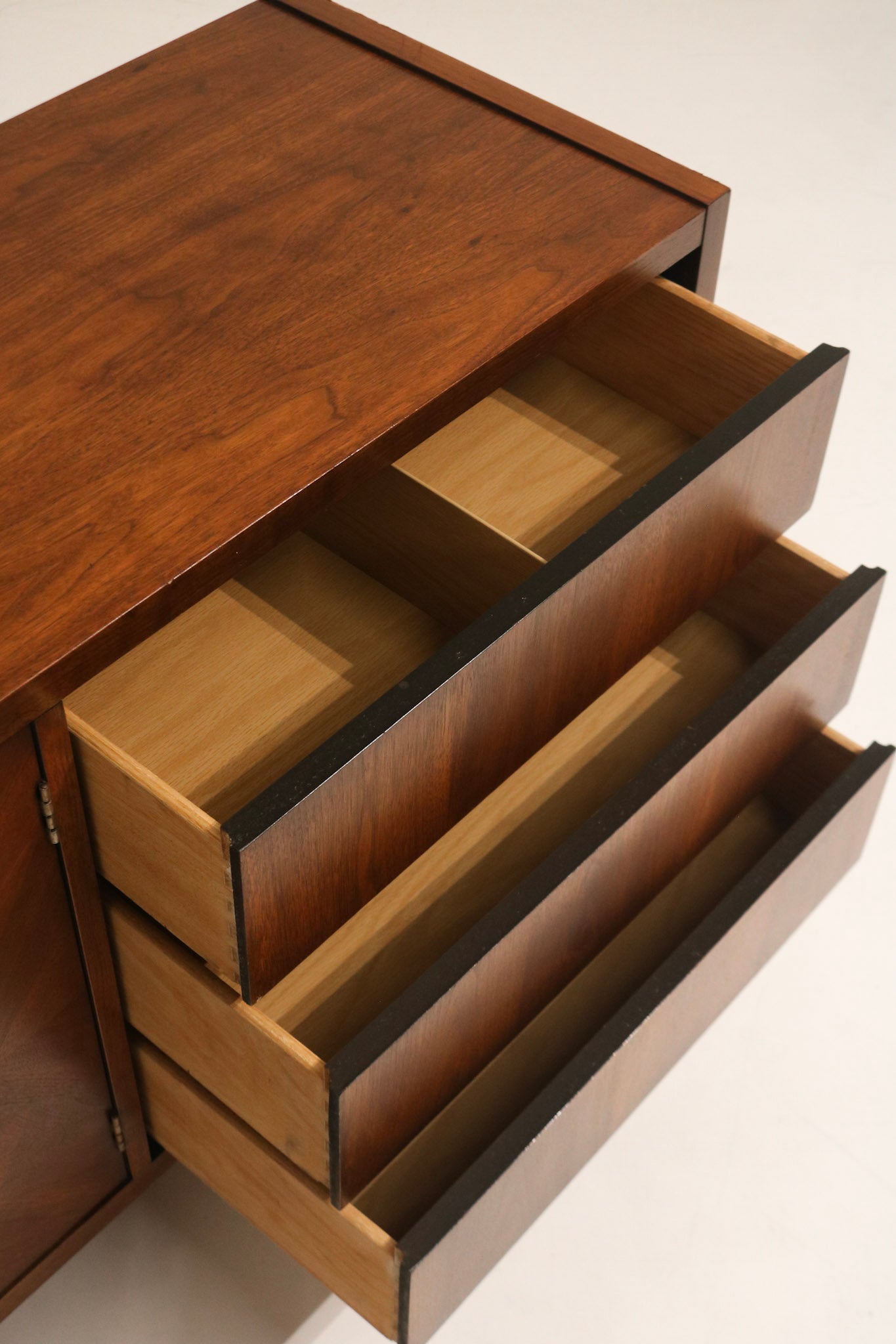 Drawer slide detail showing well functioning hardware and smooth operation, original mid-century assembly in wood drawers