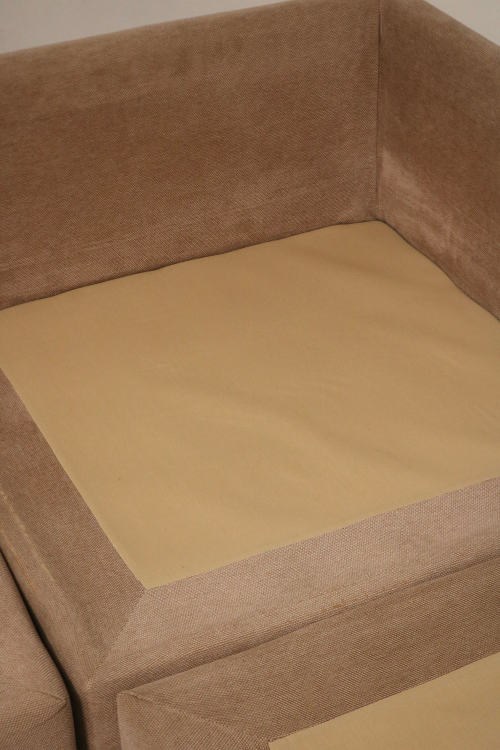 Photograph of cushion spring and interior support on fabric sofa with visible construction, foam fill appearance and vintage frame quality