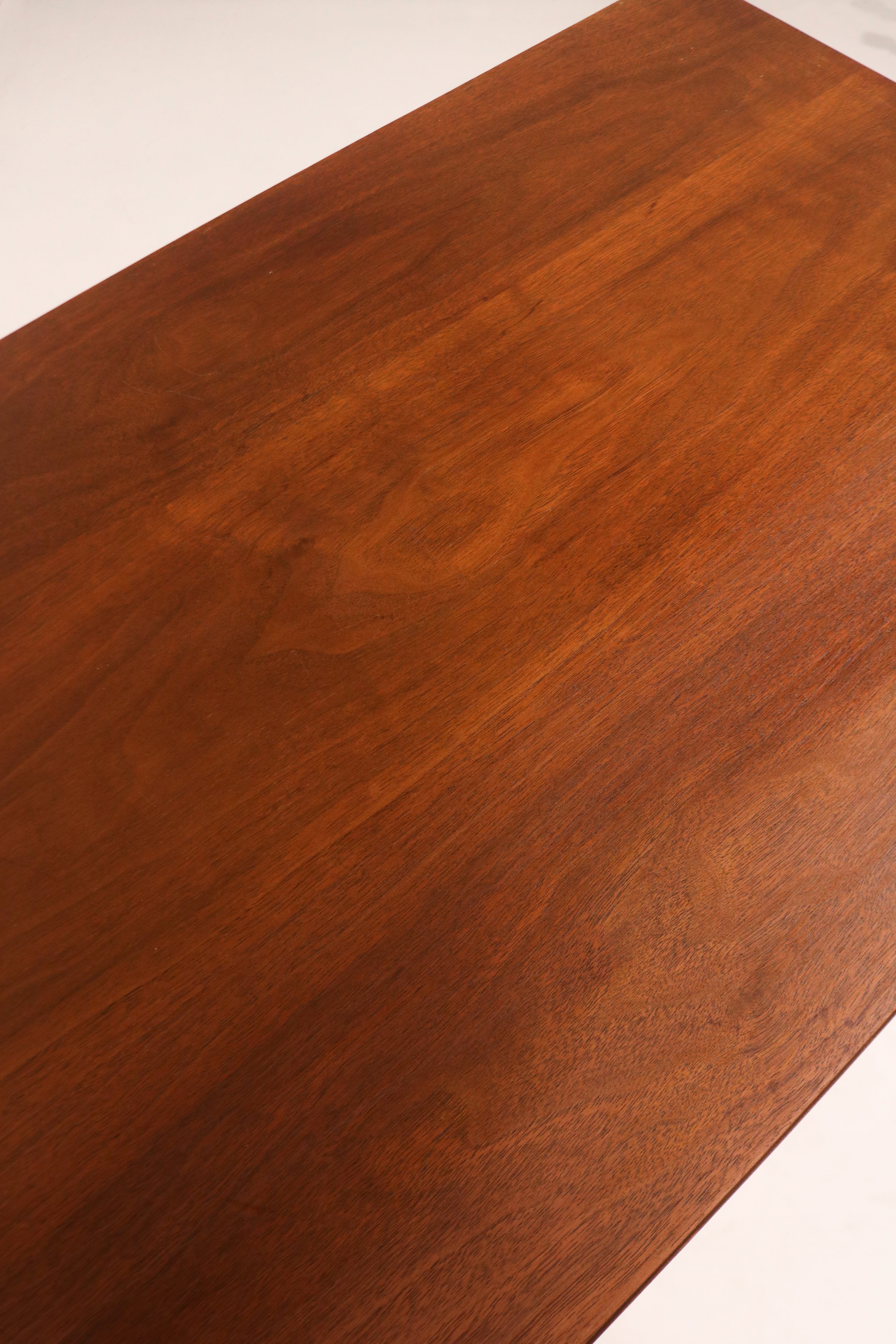 Angled shot of dresser base showing tapered legs and solid wood structure
