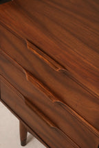 Close-up on dresser handles showing aged brass hardware and rich walnut tone