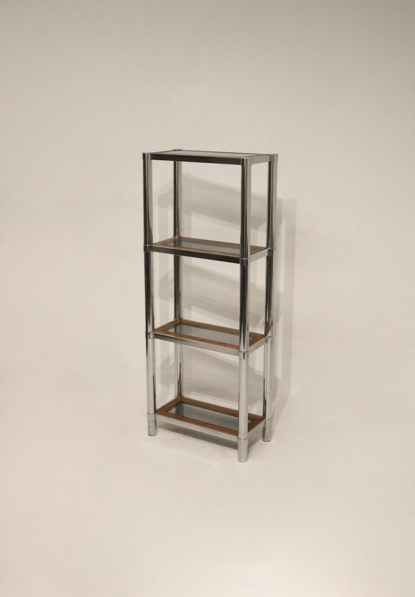 Full view of the Vintage Chrome Glass Wood Bookcase with chrome frame and wood and glass shelving