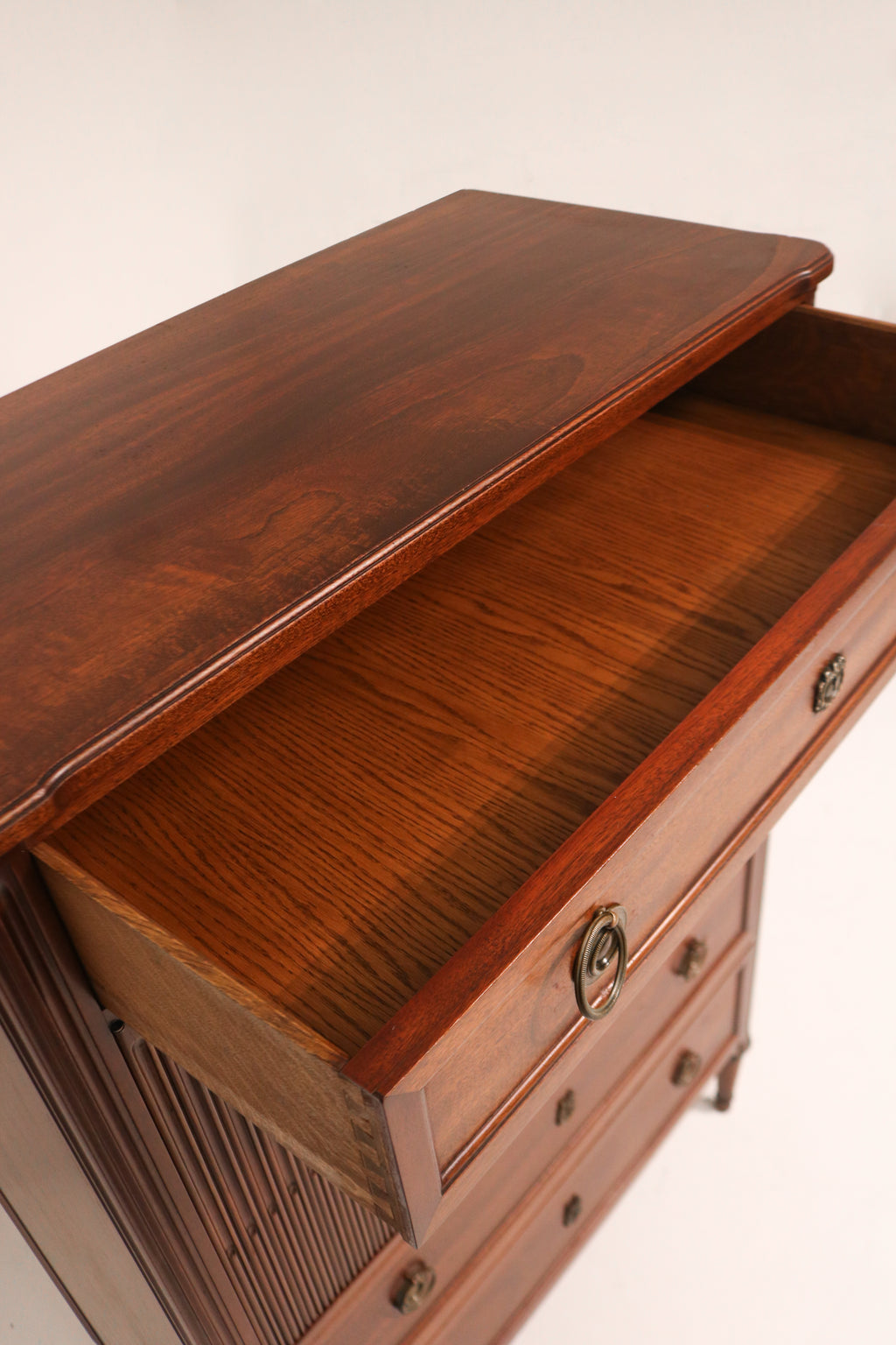 Hand touching the dresser surface to showcase the smooth finish and texture of the wood