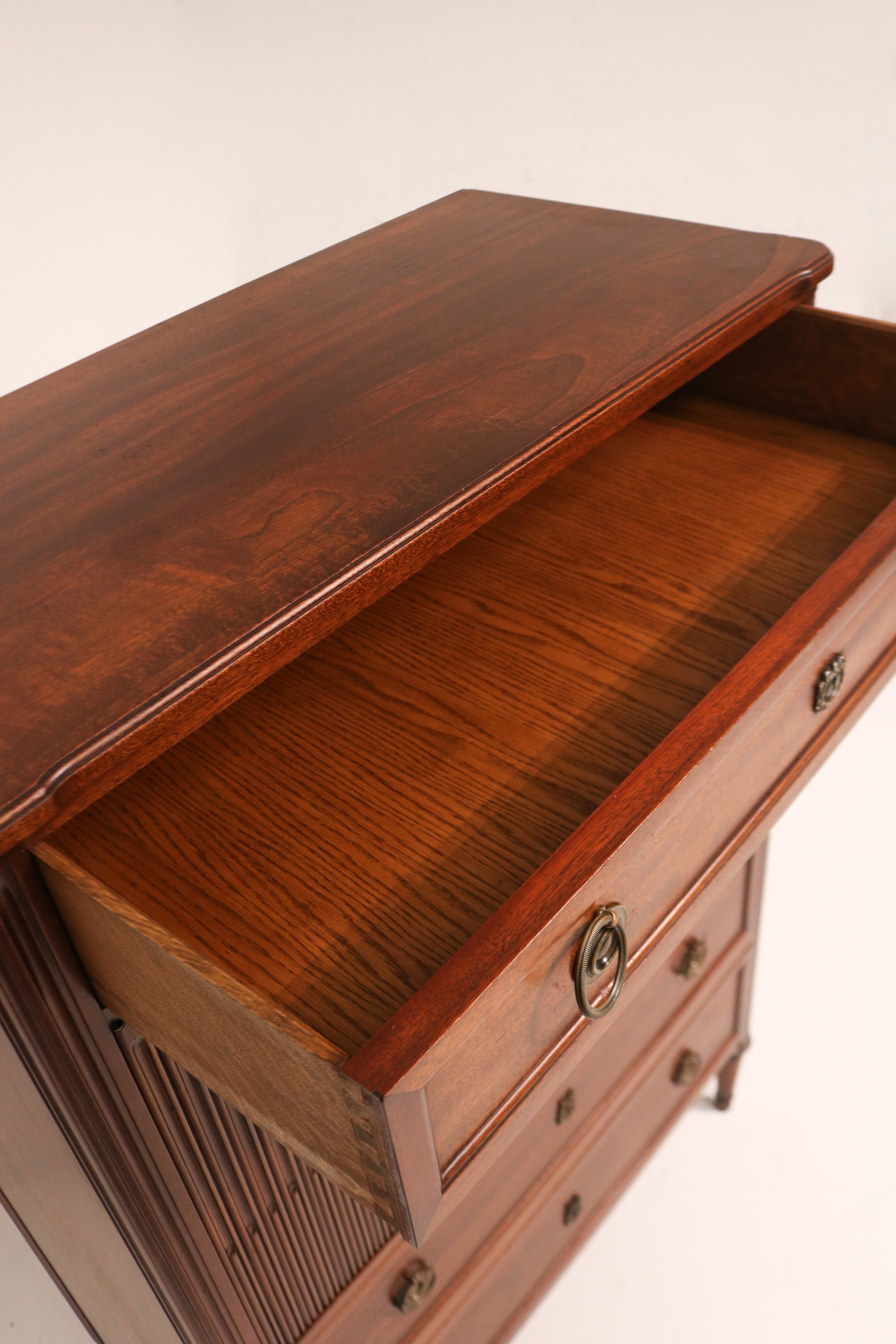 Hand touching the dresser surface to showcase the smooth finish and texture of the wood