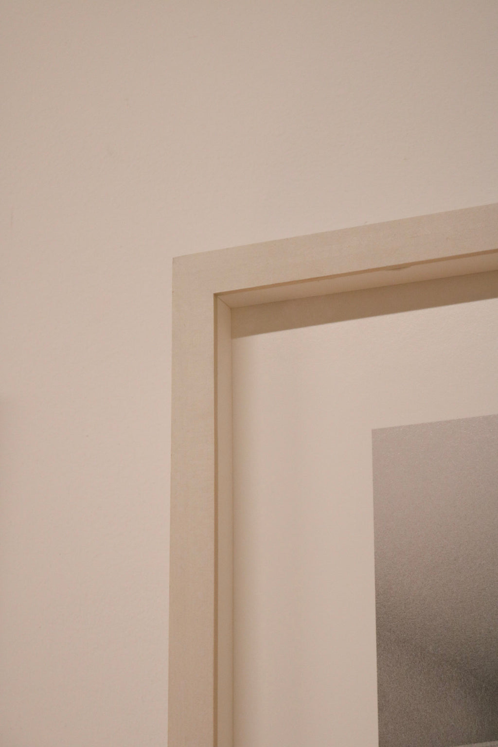 Detailed view of frame mounting hardware on Martin Schoeller’s piece, wooden structure