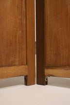 Rear view of vintage pine folding screen showing panel backs, secure hinges, consistent finish and sturdy construction.