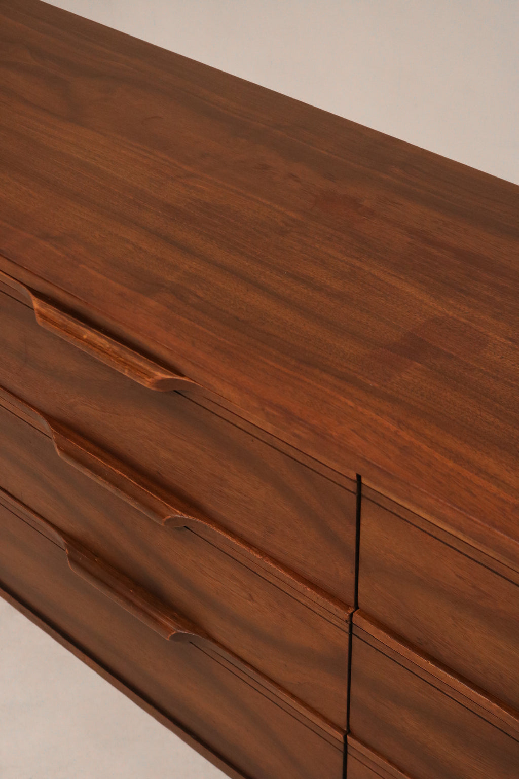 Top surface of walnut dresser displaying minor wear and original wood stain