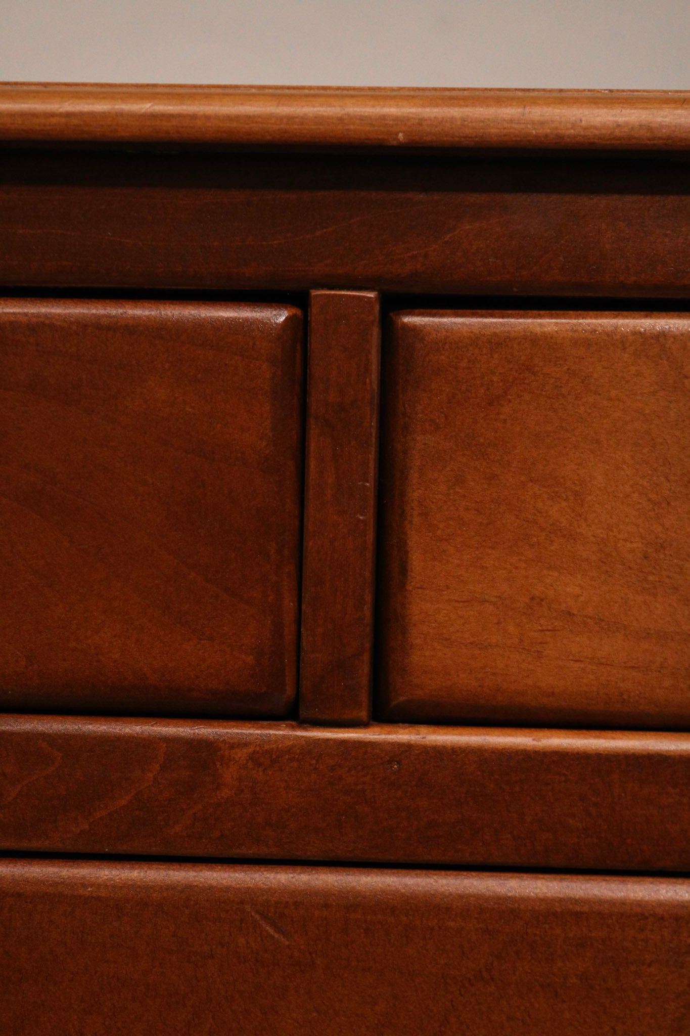 Close-up of bottom drawer edge and base molding in flawless maple craftsmanship
