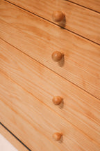 Close-up of dresser drawer handles and solid pine grain