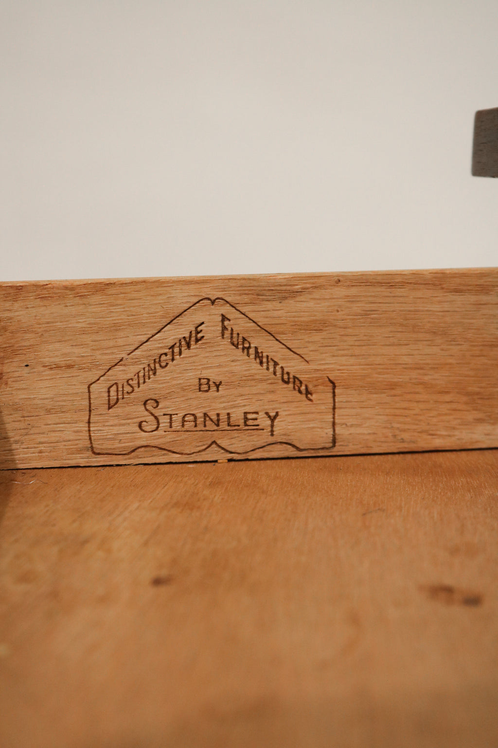 Close-up of the drawer pull with vintage-inspired design and wood contour details