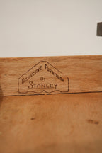 Close-up of the drawer pull with vintage-inspired design and wood contour details